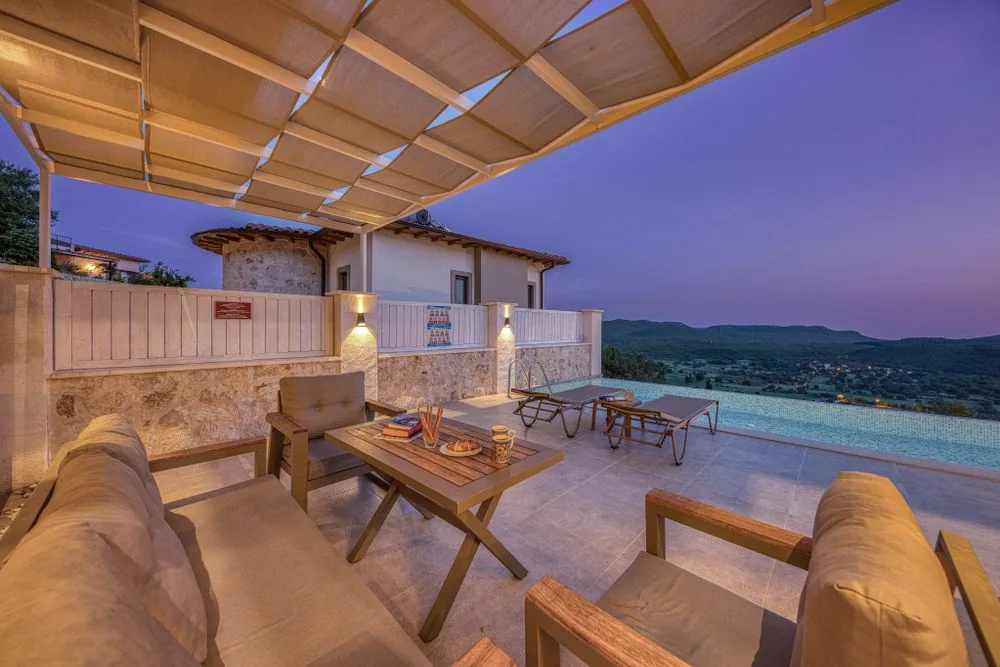 Pool viewed through a modern pergola at sunset